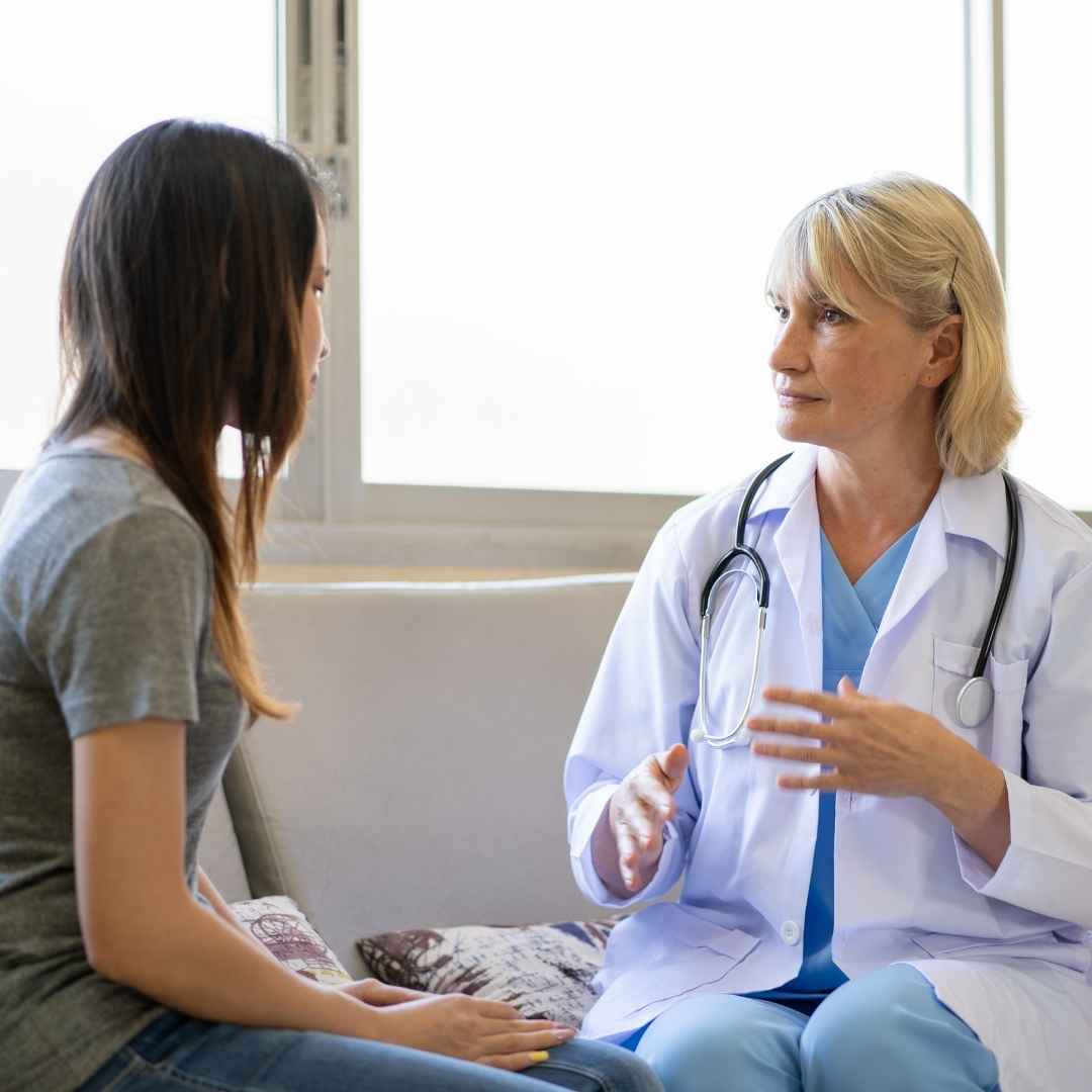 Psychiatrist talking with young patient in office.